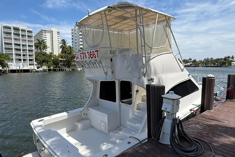 Slide: The Image of 2000 Luhrs Tournament 360 Convertible docked by waterfront buildings. - 7