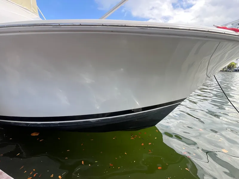 Slide: The Image of 2000 Luhrs Tournament 360 Convertible boat docked on calm water. - 8