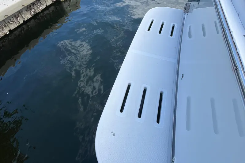 Slide: The Image of Swim platform of 2000 Luhrs Tournament 360 Convertible boat by the water. - 94