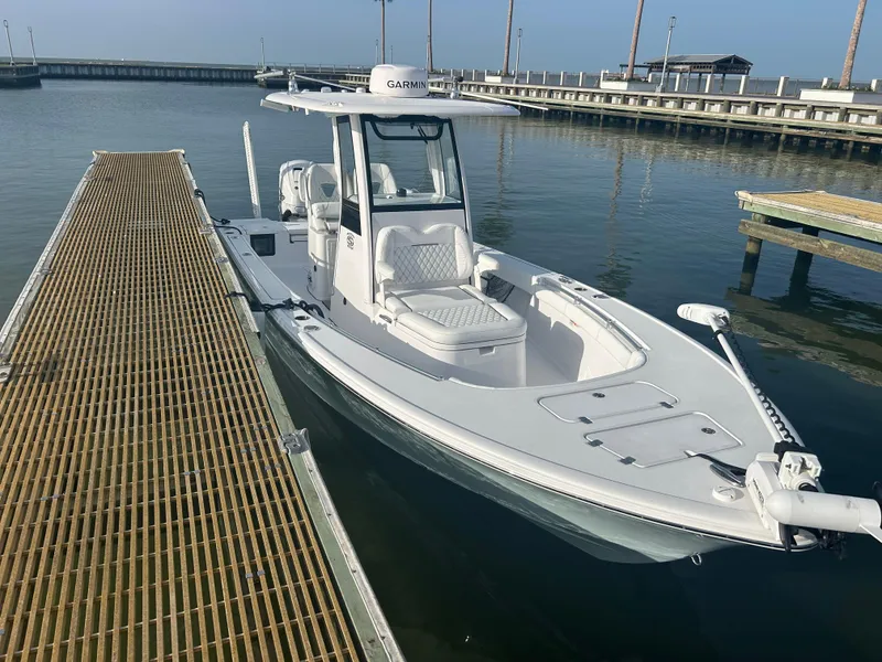 Slide: The Image of 2023 Sportsman Masters 267OE Bay Boat docked at marina. - 13