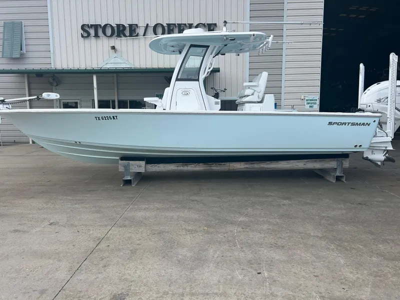 Slide: The Image of 2023 Sportsman Masters 267OE Bay Boat displayed outside store. - 14