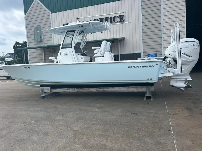 Slide: The Image of 2023 Sportsman Masters 267OE Bay Boat displayed outside a building. - 15