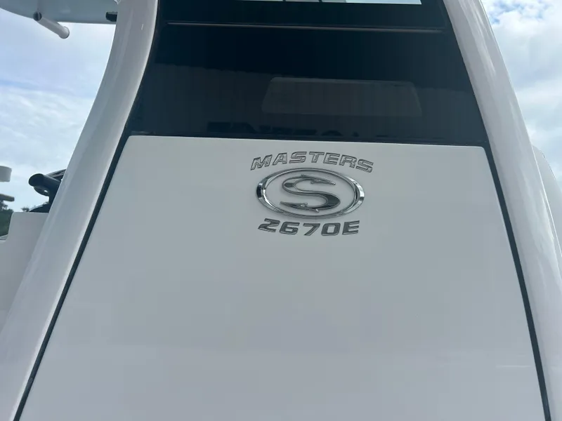 Slide: The Image of 2023 Sportsman Masters 267OE Bay Boat emblem on white surface. - 23