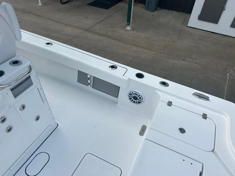 Slide: The Image of 2023 Sportsman Masters 267OE Bay Boat interior with storage and speaker. - 24