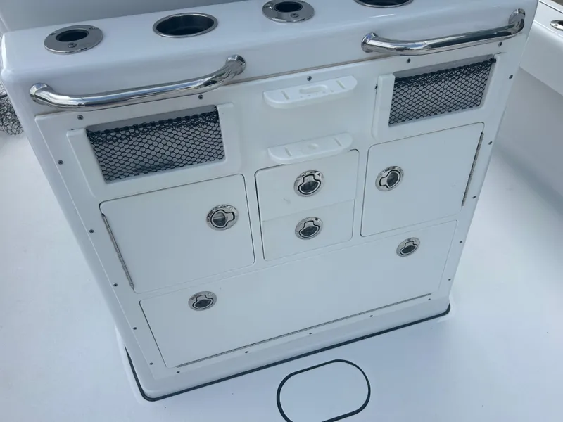 Slide: The Image of 2023 Sportsman Masters 267OE Bay Boat storage compartment with rod holders and netted pockets. - 27