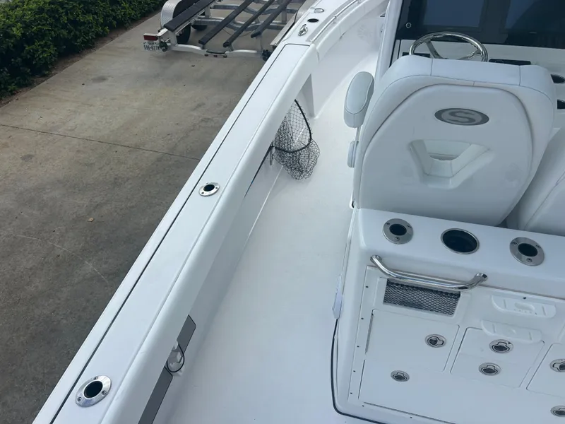 Slide: The Image of 2023 Sportsman Masters 267OE Bay Boat interior with seating and fishing rod holders. - 29