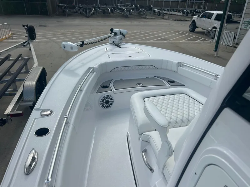 Slide: The Image of 2023 Sportsman Masters 267OE Bay Boat interior with seating and storage, parked on a trailer. - 30