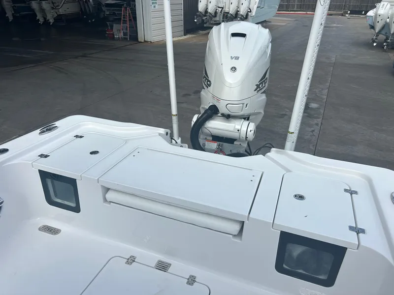 Slide: The Image of 2023 Sportsman Masters 267OE Bay Boat with powerful V8 engine in a marina setting. - 32