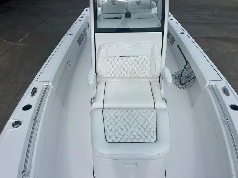 Slide: The Image of 2023 Sportsman Masters 267OE Bay Boat interior with white cushioned seating. - 33