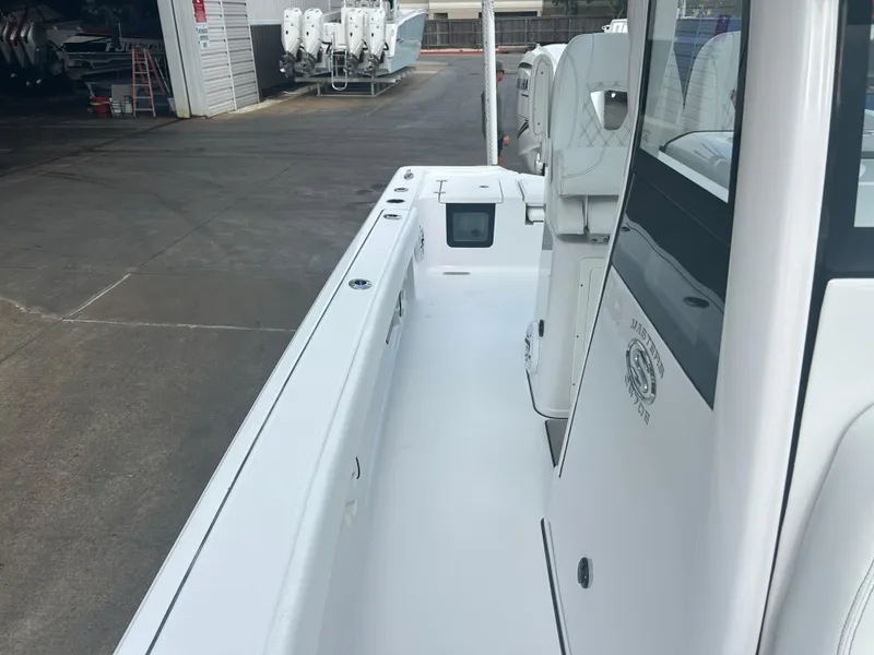Slide: The Image of 2023 Sportsman Masters 267OE Bay Boat docked, showcasing sleek design and spacious deck. - 37