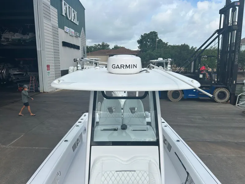 Slide: The Image of 2023 Sportsman Masters 267OE Bay Boat with Garmin equipment at a marina. - 38