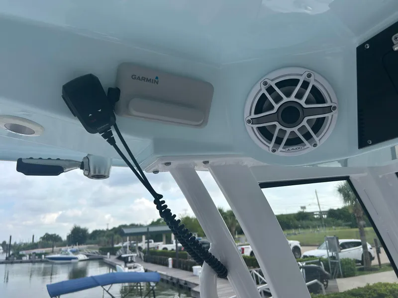 Slide: The Image of 2023 Sportsman Masters 267OE Bay Boat interior with Garmin device and JL Audio speaker. - 41