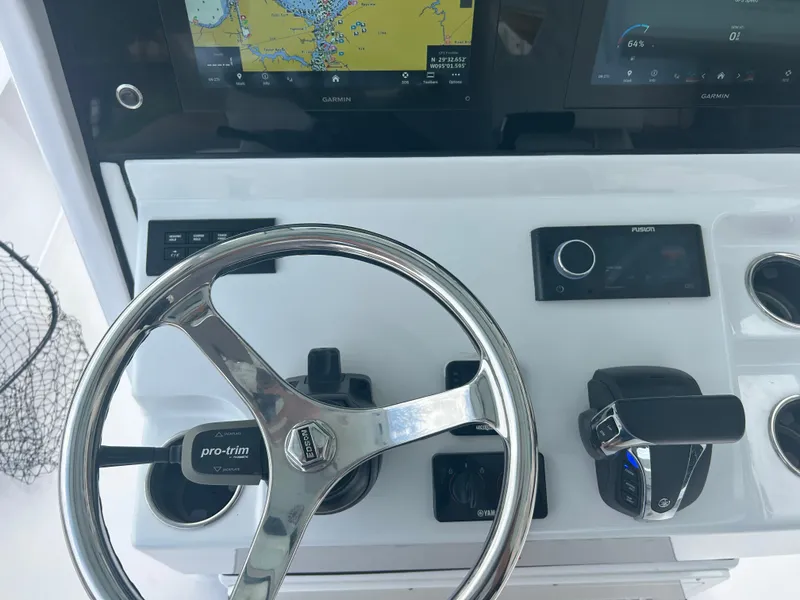 Slide: The Image of 2023 Sportsman Masters 267OE Bay Boat dashboard with steering wheel and navigation controls. - 42