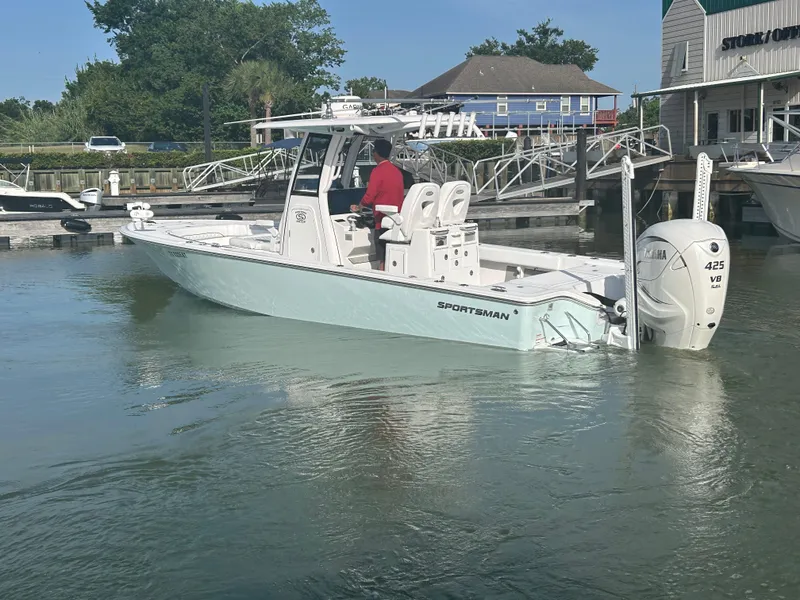 Slide: The Image of 2023 Sportsman Masters 267OE Bay Boat docked, featuring Yamaha 425 engine, calm waters, and marina backdrop. - 5