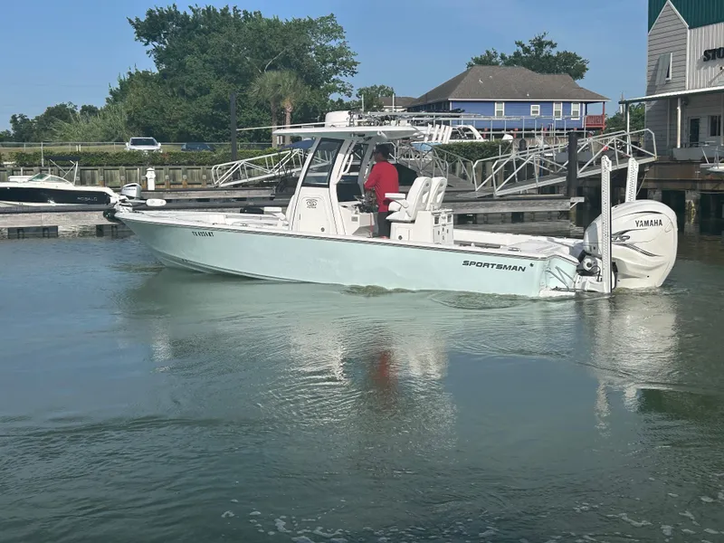 Slide: The Image of 2023 Sportsman Masters 267OE Bay Boat in marina, featuring Yamaha engine. - 6