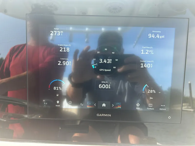 Slide: The Image of Garmin display on 2023 Sportsman Masters 267OE Bay Boat showing engine and fuel data. - 7