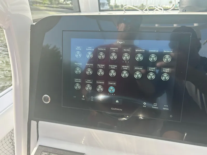 Slide: The Image of 2023 Sportsman Masters 267OE Bay Boat touchscreen control panel with various system options. - 8