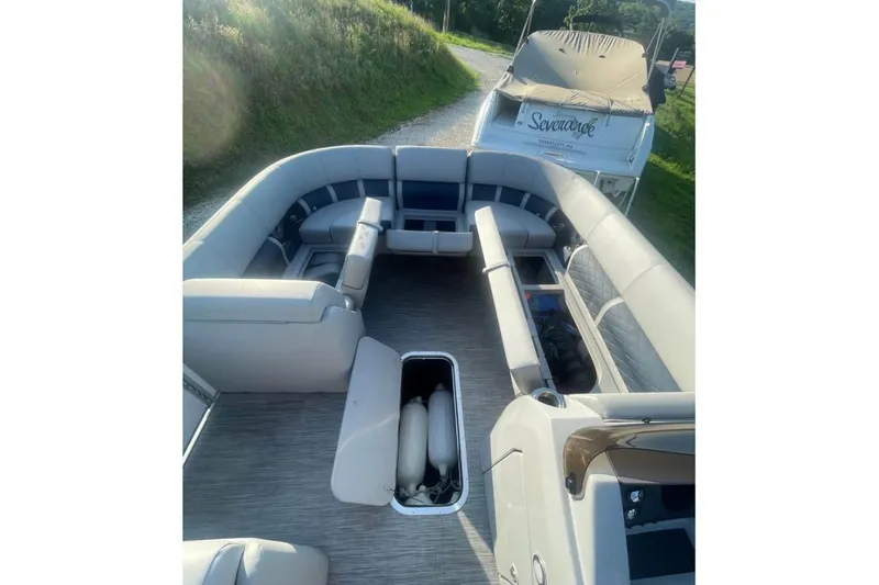 Slide: The Image of 2022 Bennington 23 LSB pontoon boat interior with spacious seating and storage compartments. - 10