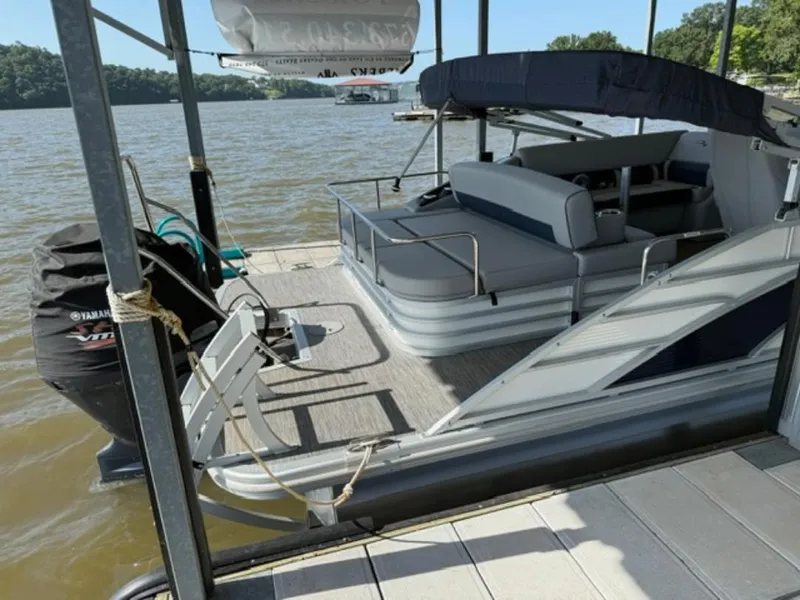 Slide: The Image of 2022 Bennington 23 LSB pontoon boat docked on a sunny lake. - 3