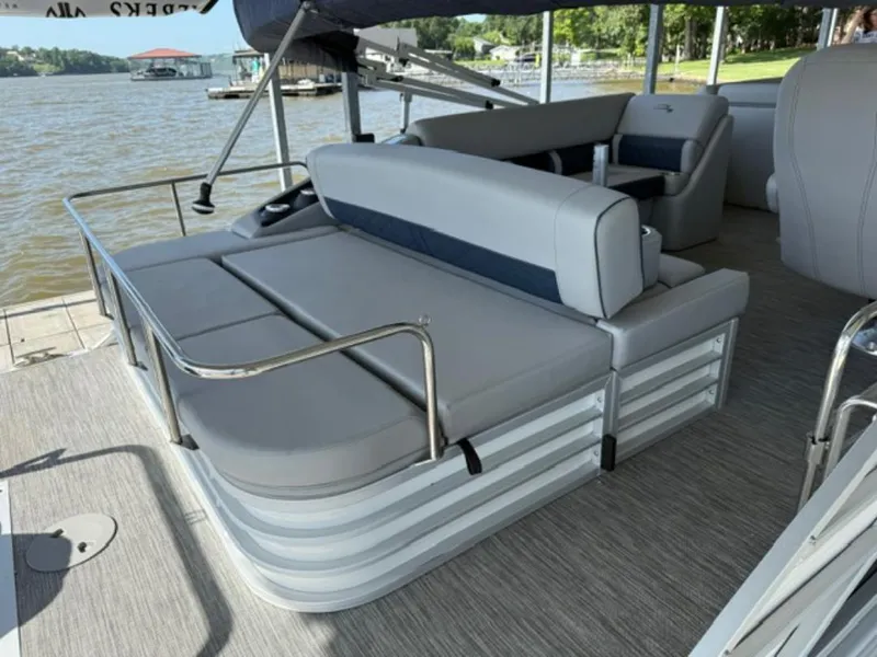 Slide: The Image of 2022 Bennington 23 LSB pontoon boat with spacious seating and scenic lake view. - 5