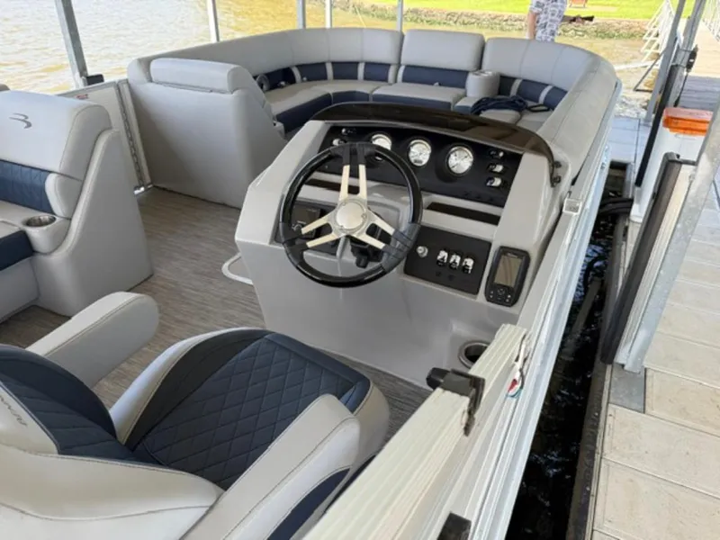 Slide: The Image of 2022 Bennington 23 LSB boat interior with steering wheel and seating area. - 6