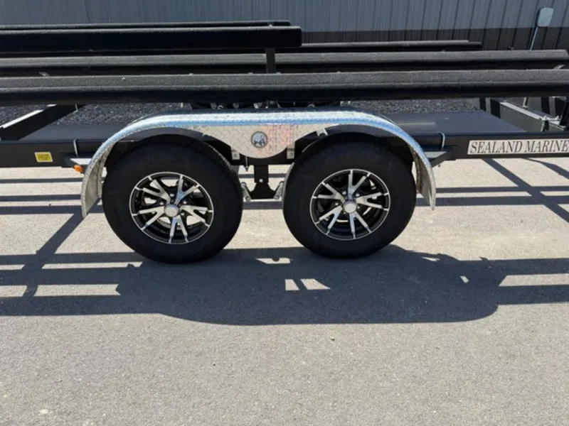 Slide: The Image of Trailer wheels for 2022 Bennington 23 LSB boat, featuring dual axles and metallic fenders. - 9