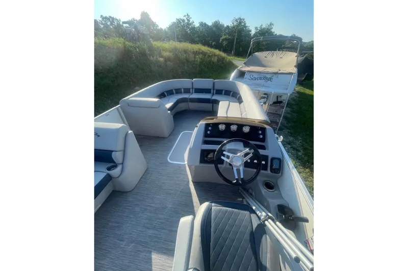 Slide: The Image of 2022 Bennington 23 LSB pontoon boat interior with steering wheel and seating. - 12