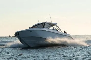 Slide: The Image of Manufacturer Provided Image: 2019 Everglades 340 Dual Console boat cruising on open water. - 1