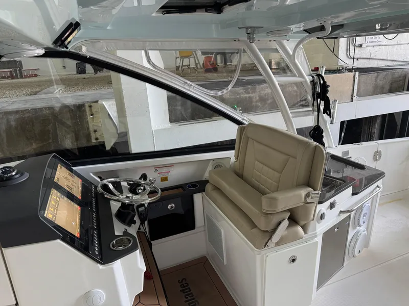 Slide: The Image of 2019 Everglades 340 Dual Console boat interior with steering wheel and navigation display. - 13