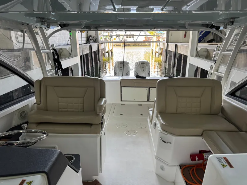 Slide: The Image of Interior view of a 2019 Everglades 340 Dual Console boat with beige seating. - 14