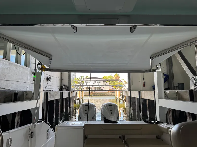 Slide: The Image of 2019 Everglades 340 Dual Console boat docked in a marina with covered seating area. - 20