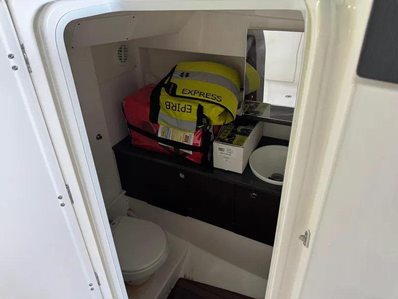 Slide: The Image of Interior of 2019 Everglades 340 Dual Console boat with storage and sink. - 5