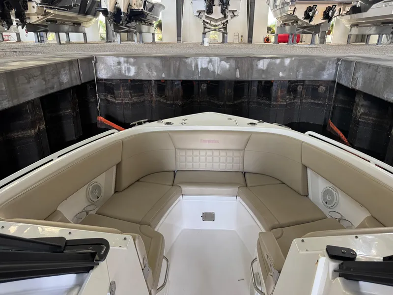 Slide: The Image of 2019 Everglades 340 Dual Console boat interior with beige seating in storage facility. - 9