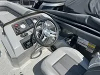 Slide: The Image of 2025 Bennington 25 SXSR boat dashboard and steering wheel, featuring modern controls and seating. - 18