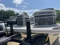 Slide: The Image of 2025 Bennington 25 SXSR pontoon boat on trailer under clear blue sky. - 4