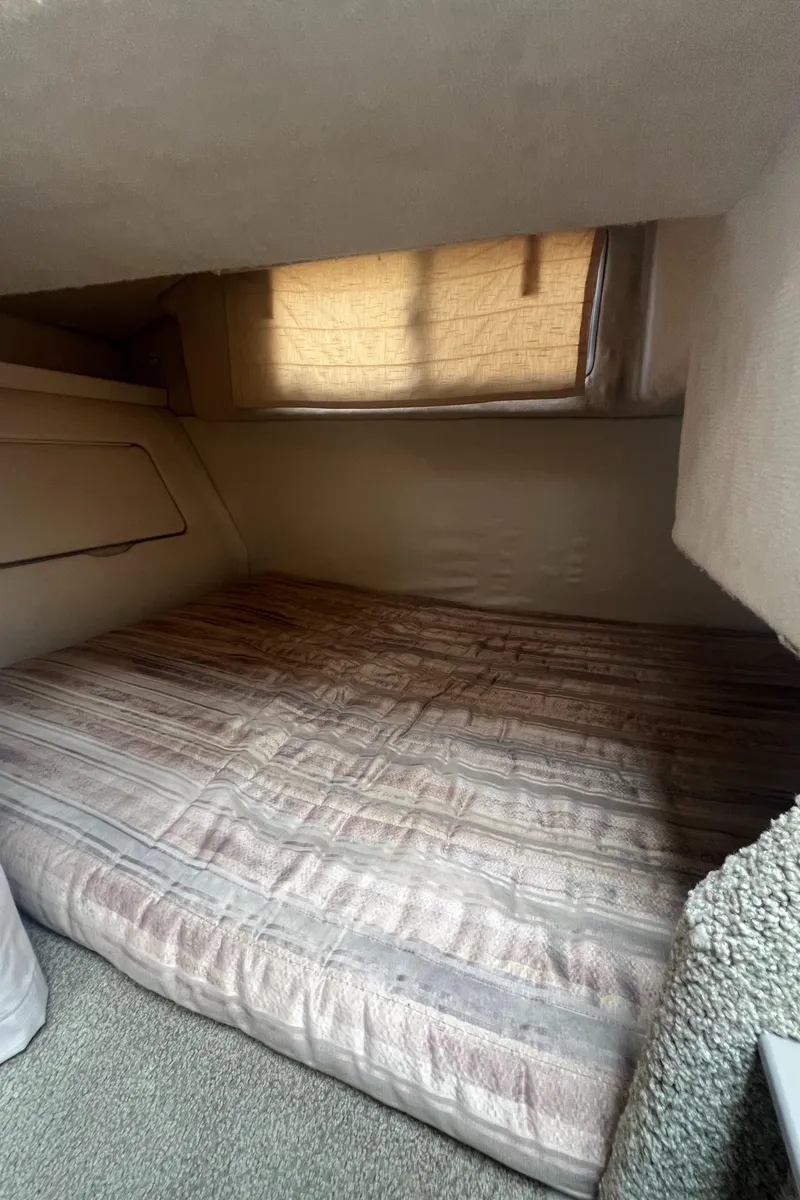 Slide: The Image of Cozy cabin interior of 1997 Maxum 2800 SCR boat with a comfortable bed. - 15