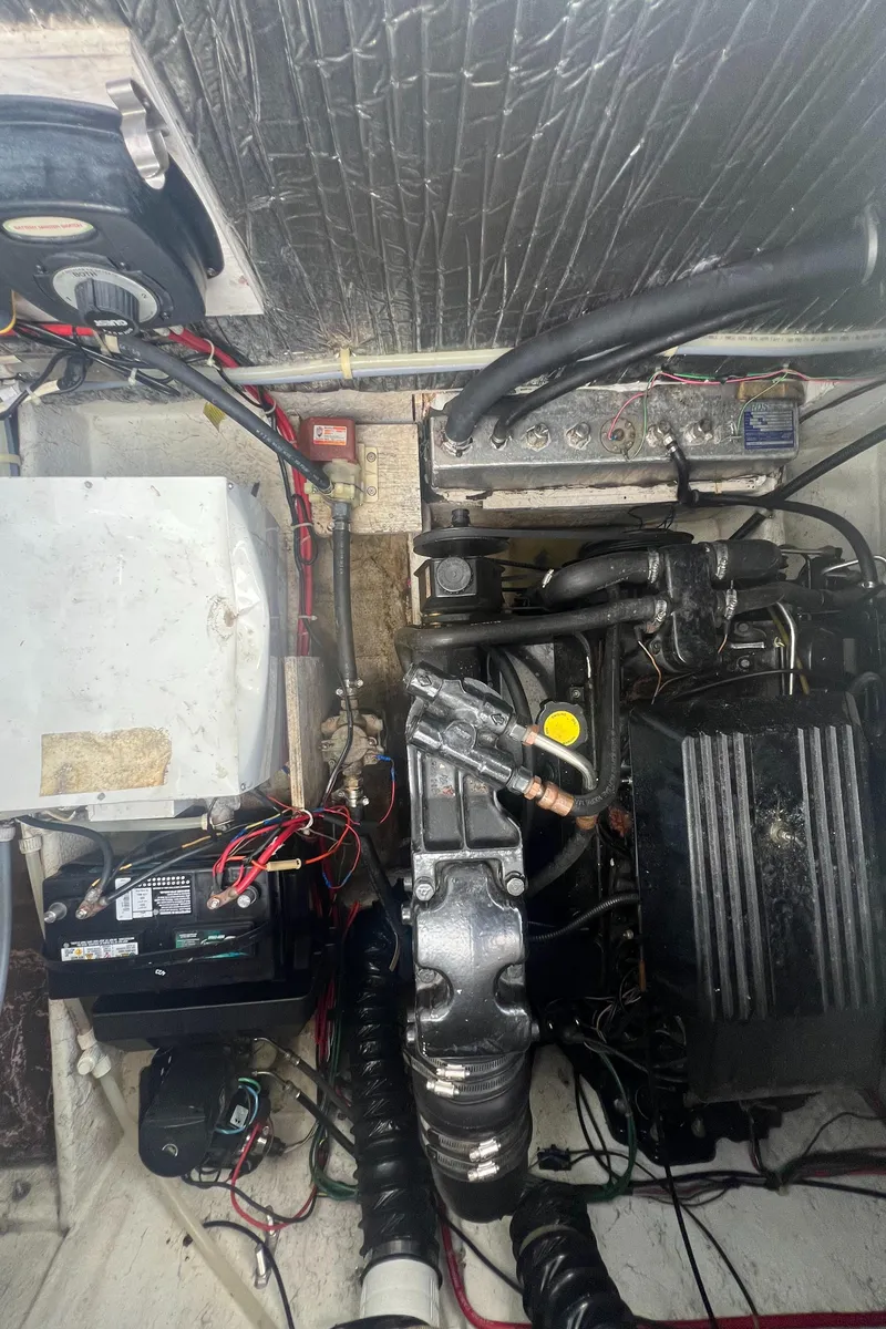 Slide: The Image of Engine compartment of a 1997 Maxum 2800 SCR boat, showing mechanical components and wiring. - 16