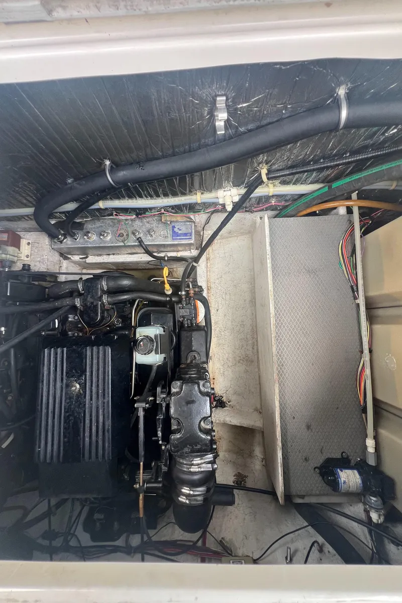 Slide: The Image of Engine compartment of a 1997 Maxum 2800 SCR boat, showing mechanical components and wiring. - 17