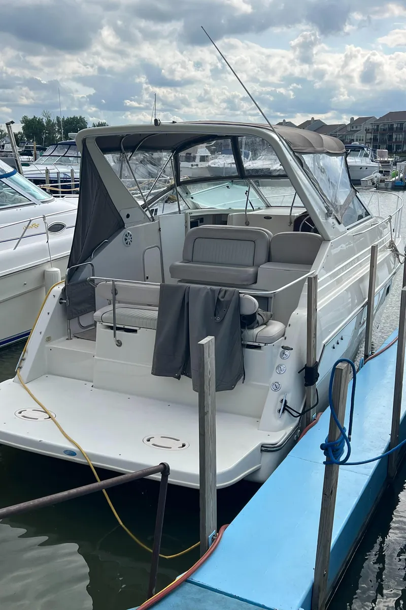Slide: The Image of 1997 Maxum 2800 SCR boat docked at marina under cloudy sky. - 3