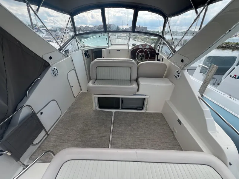 Slide: The Image of 1997 Maxum 2800 SCR boat interior with seating, steering wheel, and carpeted floor. - 6