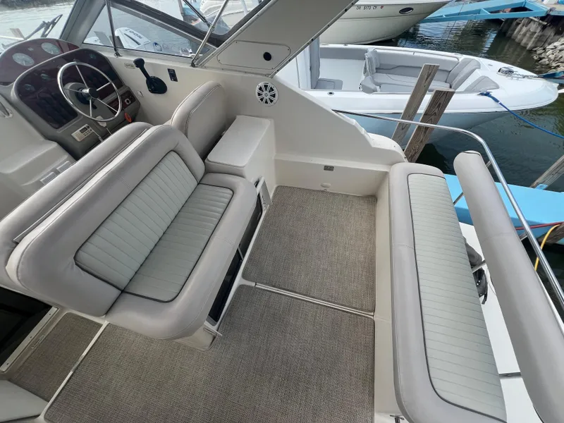 Slide: The Image of 1997 Maxum 2800 SCR boat interior with cushioned seating and steering wheel. - 7