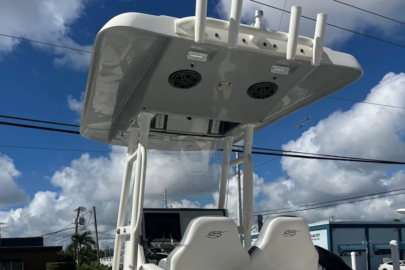 Slide: The Image of 2020 ShearWater 270 Carolina Flare boat with T-top and electronics, under a blue sky. - 2
