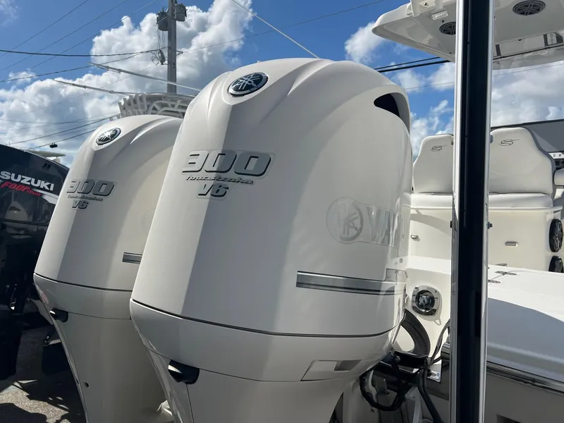 Slide: The Image of Twin Yamaha 300 V6 outboard engines on a 2020 ShearWater 270 Carolina Flare boat. - 4