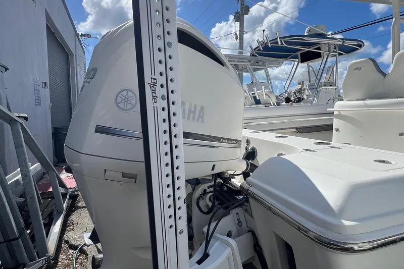 Slide: The Image of 2020 ShearWater 270 Carolina Flare boat with Yamaha engine, docked under blue sky. - 5