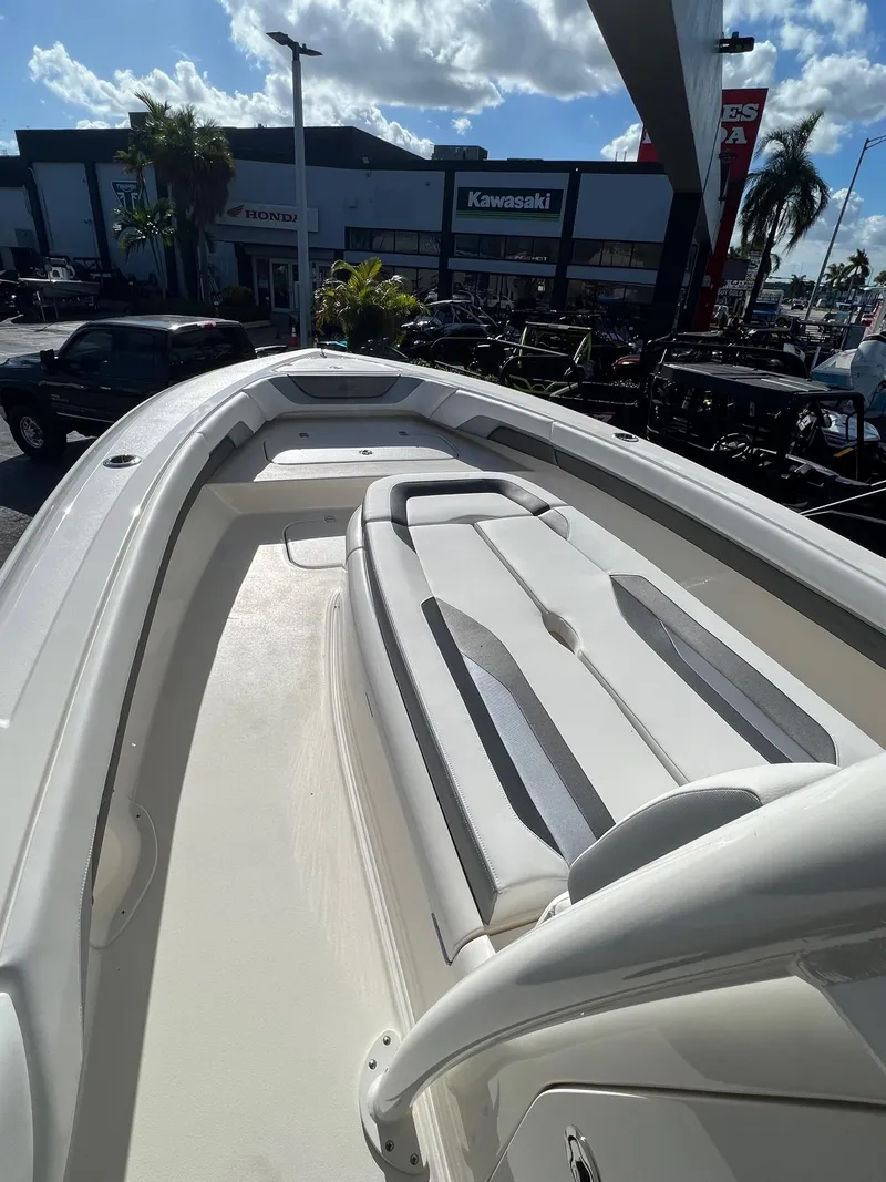 Slide: The Image of 2020 ShearWater 270 Carolina Flare boat with spacious seating, displayed outdoors under a sunny sky. - 7