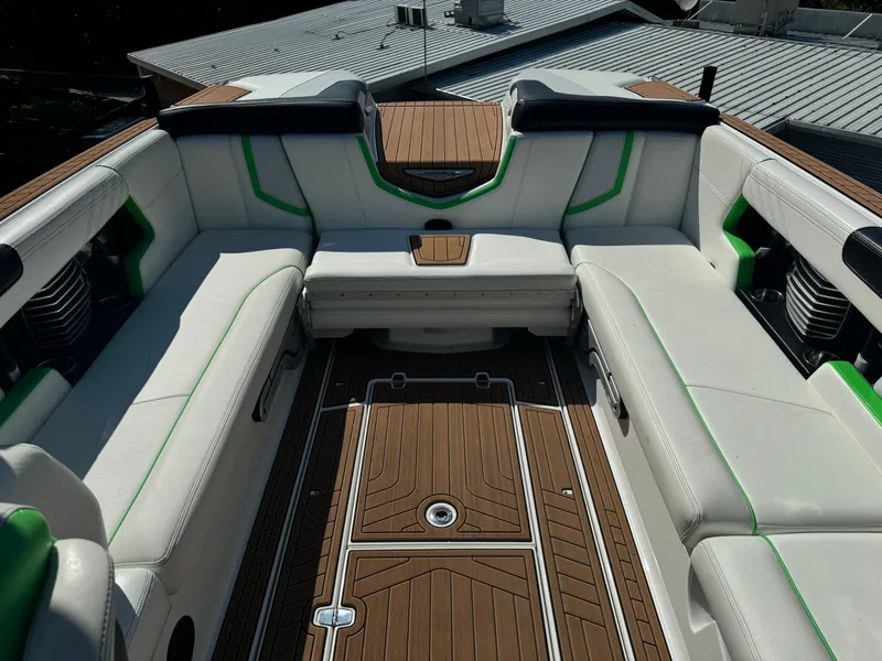 Slide: The Image of 2017 Nautique Super Air Nautique G25 interior with white seating and wood flooring. - 10