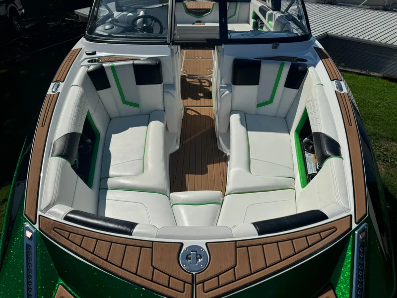 Slide: The Image of 2017 Nautique Super Air Nautique G25 boat interior with white and green seating. - 11