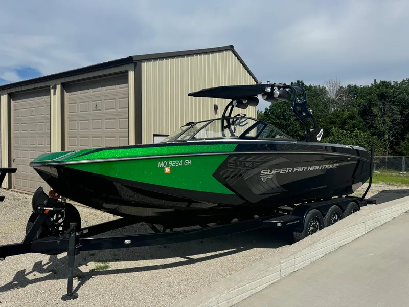 Slide: The Image of 2017 Nautique Super Air Nautique G25 boat in vibrant green on trailer. - 4