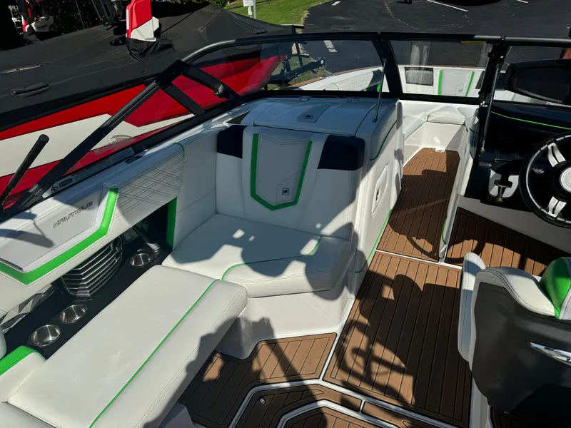 Slide: The Image of 2017 Nautique Super Air Nautique G25 interior with white and green seating, wood flooring. - 7