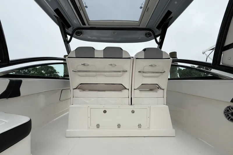 Slide: The Image of 2021 Chaparral 300 OSX boat interior with dual seats and sleek design. - 13